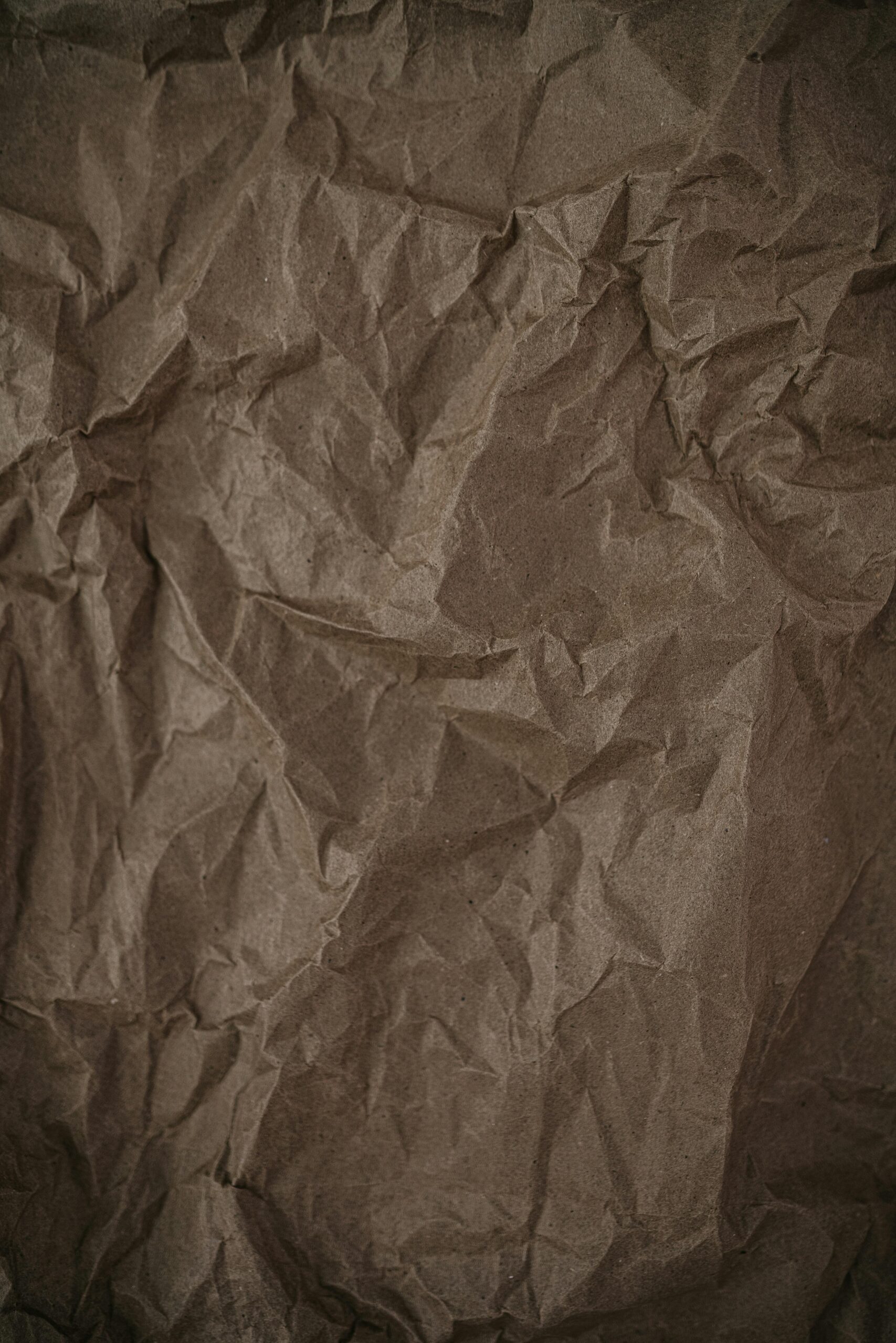 Close-up of a crumpled brown paper texture, perfect for backgrounds and abstract projects.
